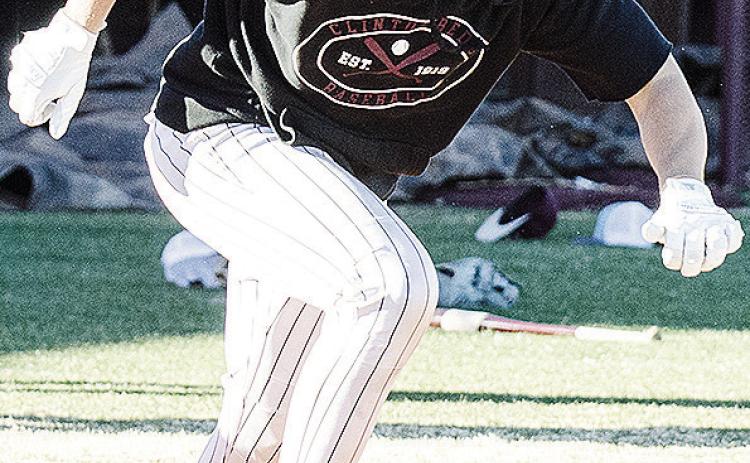 Clinton’s Vince Jones hustles away from home plate to first during a batting drill in baseball practice. CDN | Sam Goodwyn