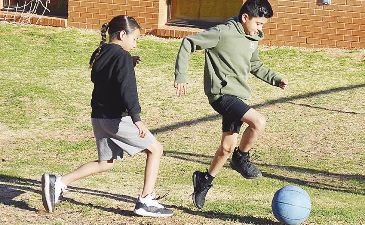 Bryan Rodriguez Guerra, right, outraces Na’tsis’ta Black for the soccer ball during recess at Southwest. CDN | Sam Goodwyn