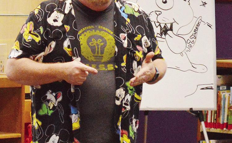 Professional storyteller Will Stuck tells the audiences a story about an alien they helped create during the WPLS Summer Reading Program’s weekly performance Wednesday at the Clinton Public Library. CDN | Micah Ashcraft