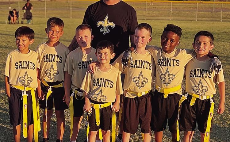 The Saints youth flag football team poses for a team photo after participating in the tournament at Schumacher Fields at Acme Brick Park. Pictured front, from left, are Liam Perez, Kolt Lovelace, Brodie Gibson, Corbin Dearborn, Isaac Stratton, Kamari Hawthorne, and Conner Dearborn; back, Coach Kaden Lovelace. CDN |Courtesy Photo