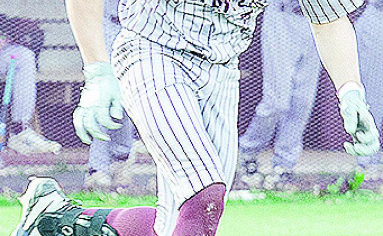 Clinton’s Easten Powell speeds toward first during the Reds’ win over Western Heights. CDN | Sam Goodwyn