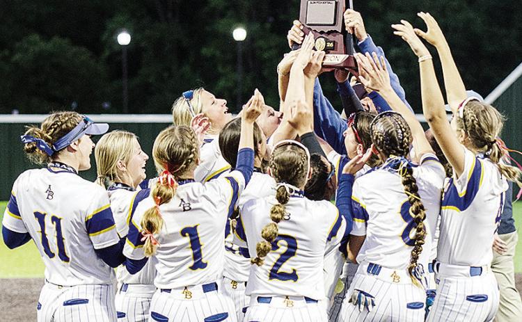 The Arapaho-Butler Lady Indians slow-pitch softball team surrounds Principal Jared Cudd, as he raises the Class 3A State Championship Trophy following the team’s 13-2 win over Caddo Wednesday at the FireLake Ball Fields. CDN | Sam Goodwyn