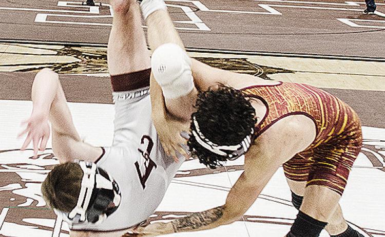 Clinton’s Tristan Cardenas, right, throws his opponent to the mat during the District Duals in Elk City. CDN | Sam Goodwyn
