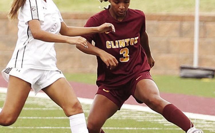 Clinton’s Peyton Clonce, right, tries to avoid the Elk City defender during the Lady Reds’ home game against the Elkettes in the spring. CDN | Steve Wheeler