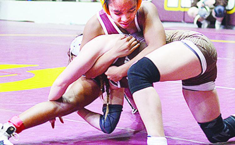 Clinton’s Peyton Clonce wraps her opponent up to avoid a single-leg takedown during the Hub City Wrestling Tournament held at the Tornado Dome. CDN | Sam Goodwyn