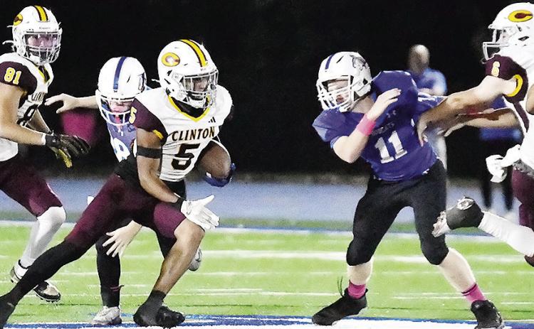 Clinton’s No. 81 Judd Hall and No. 6 Benton Bridgeman provide key blocks to help spring Jesus Gutierrez and allow him to carry the ball for a big gain Friday against Bridge Creek. CDN | John Kinsey