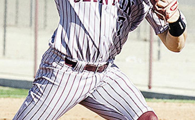 Clinton’s Easten Powell hurls the pitch during the Reds’ narrow win Friday at home over El Reno. CDN | Sam Goodwyn