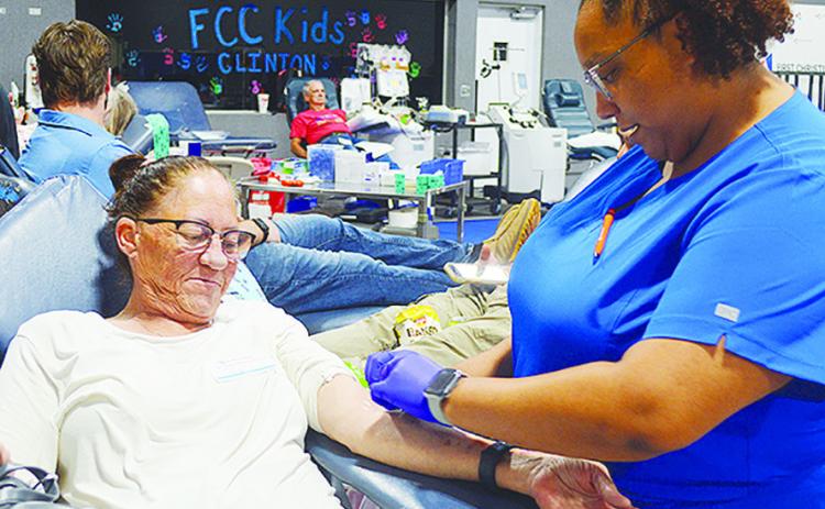 Sherry Ernst, left, is prepped to donate blood by Whitney Gilder Tuesday afternoon at the blood drive held at the First Christian Church’s Family Life Center. CDN | Micah Ashcraft