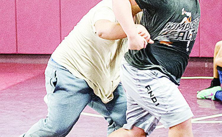 Clinton’s Isaiah Dustman, right, breaks free of Sammy Zheng’s grasp during an open gym practice over winter break in the wrestling room. CDN | Sam Goodwyn