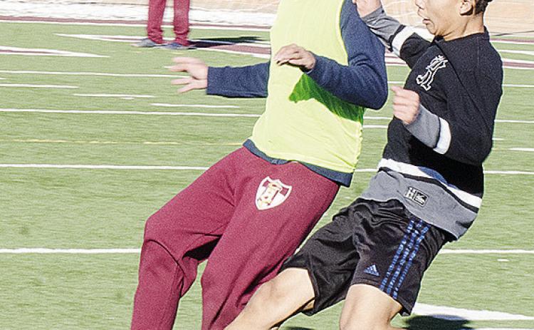 Clinton’s Miguel Zuniga Hernandez, left, and Luis Velez fight for the ball during practice in the Tornado Bowl. CDN | Sam Goodwyn