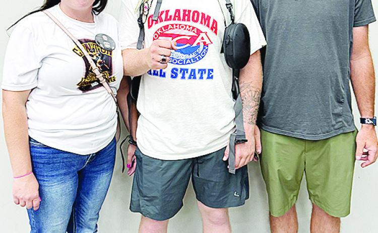 Clinton’s Marcus Wilson celebrates competing at the All-State wrestling match with his mom Shy’An Madison, left, and his dad Dallas Wilson. CDN | Courtesy photo