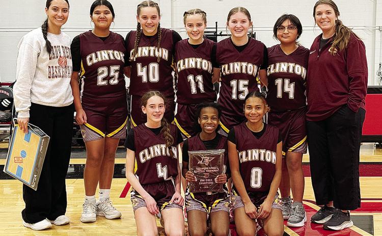 Clinton’s seventh-grade girls’ basketball team is all smiles after winning the Enid eighth-grade basketball tournament. Pictured, from left, kneeling are Madilyn Ruyle, Kynnedi Jefferson and Catileya Huddlen; back, Coach Mariah Espinosa, Daniaya Redsh
