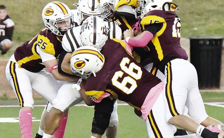 No. 25 Gavin Evans, No. 66 Andre Lime, No. 15 Dyson Moss and No. 7 Easten Powell take down the Elk City ball carrier during Clinton’s win Friday over the Elks in the Tornado Bowl. CDN |John Kinsey