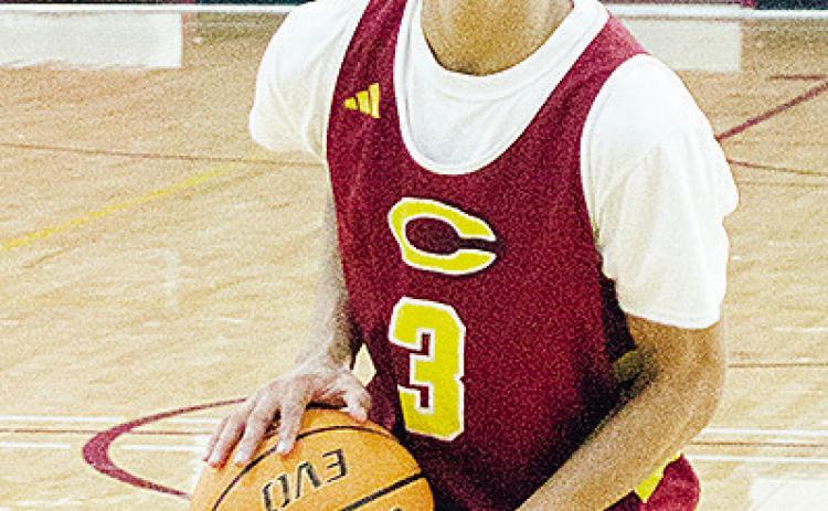 No. 3 Titan Malone aims the ball at the hoop during basketball practice. CDN | Sam Goodwyn