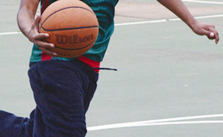 Omar Calixto runs up to the basket during a two-on-two game Tuesday afternoon at the McLain Rogers Park basketball court. CDN | Christian Jacobson
