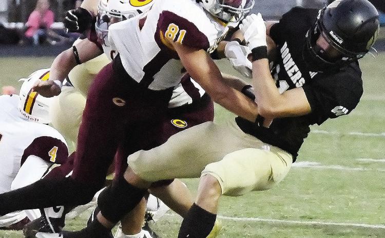 Clinton’s Ben Daugherty levels the Woodward ballcarrier during the Red Tornadoes’ win over the Boomers Thursday in Woodward. CDN | John Kinsey