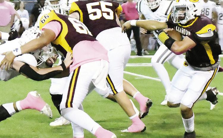 Clinton’s Easten Powell, right, carries the ball while No. 66 Andre Lime and No. 55 Bryson Snider provide blocks during the Red Tornadoes’ home win over Elk City Friday. CDN | John Kinsey