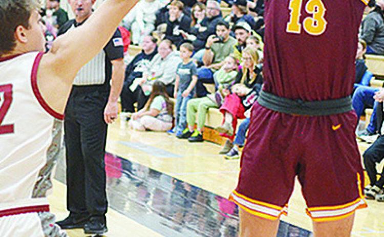 No. 13 Ethan Lofland shoots over an Eagles defender during Clinton’s road game in Weatherford. CDN | Sam Goodwyn