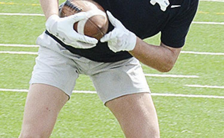 Clinton’s Dyson Moss steadies his feet after catching the ball during the first day of practice Monday in the Tornado Bowl. CDN | Sam Goodwyn