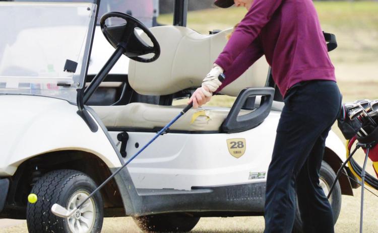 CDN | Collin Wieder Clinton senior golfer Kennedy Meacham swings through the ball at the Weatherford Tournament last year. Meacham averaged a sub-100 score for the season, helping the Lady Reds to the state tourney.