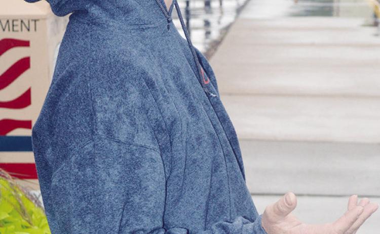 Tucker Anders heads back into the rain at Clinton City Hall for his job working with the City of Clinton. CDN | Christian Jacobsen