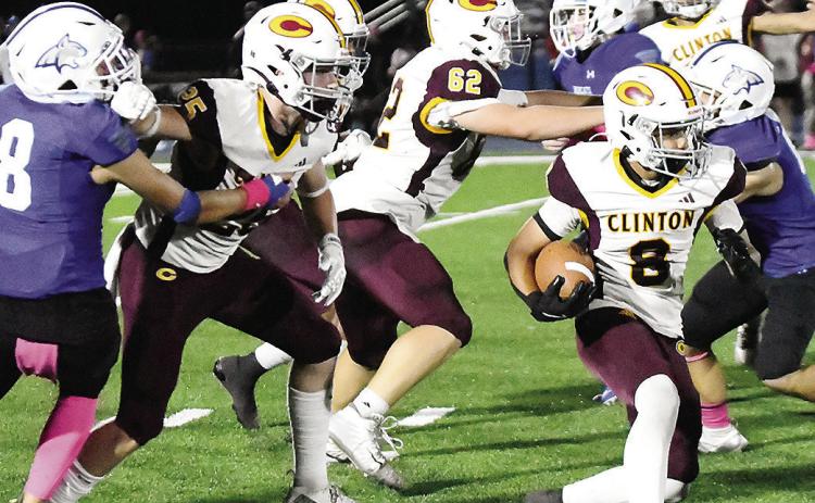 Clinton’s No. 8 Jaden Potter carries the ball as No. 25 Gavin Evans and No. 62 Layne Spitz provide blocks for him during the Red Tornadoes’ road game Friday against Bridge Creek. CDN | John Kinsey