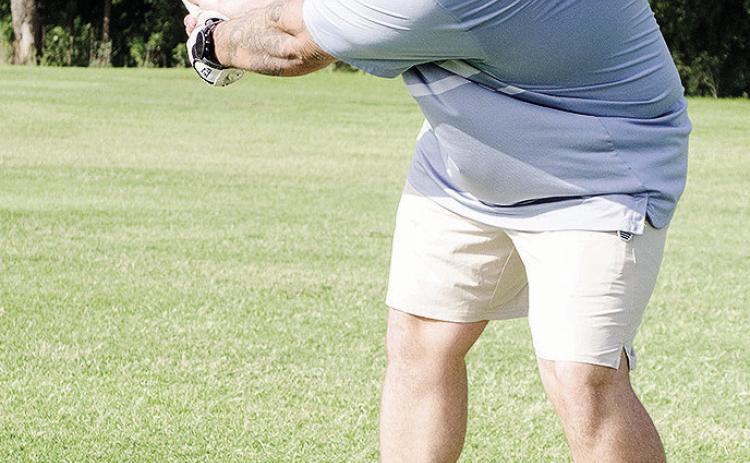 Austin Long raises his golf club as he prepares to hit the ball at Riverside Golf Course. CDN | Sam Goodwyn
