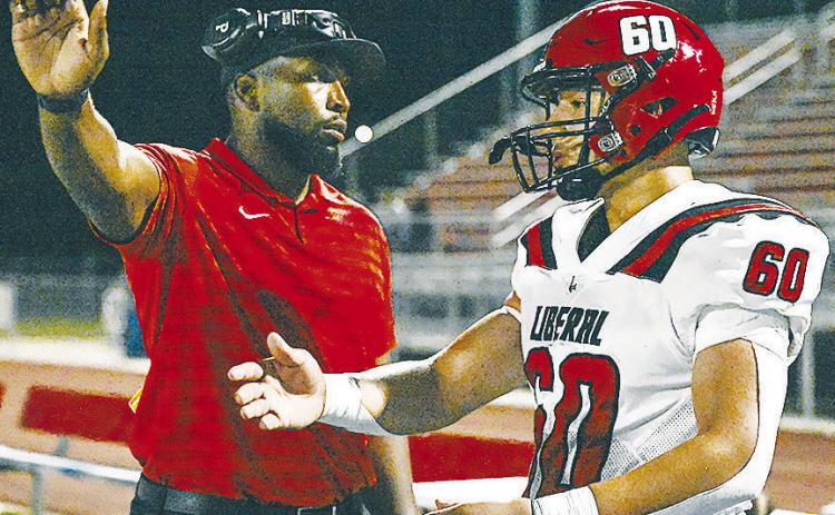 New Clinton offensive and defensive line Randy Powell, left, directs recent Liberal graduate Emilio Sandoval during a game last season. CDN | Courtesy photo