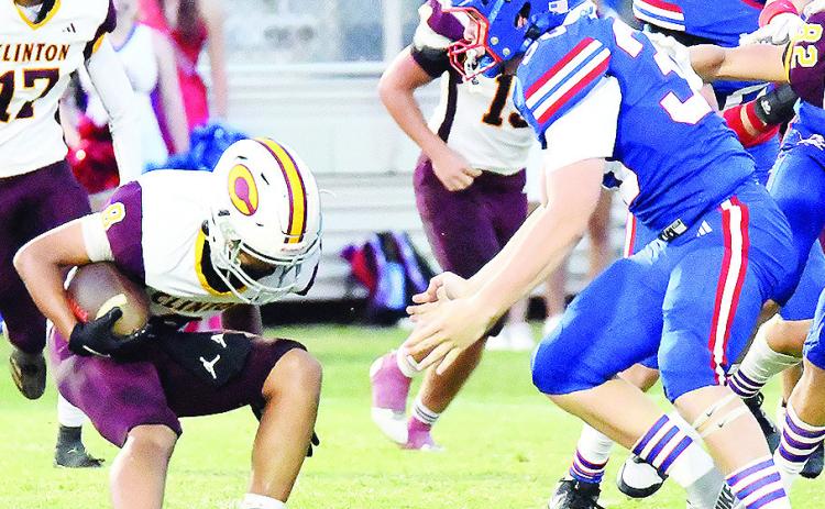 Clinton’s Jaden Potter, left, looks to avoid a tackle during the Red Tornadoes’ road game Friday against Chandler. CDN | John Kinsey