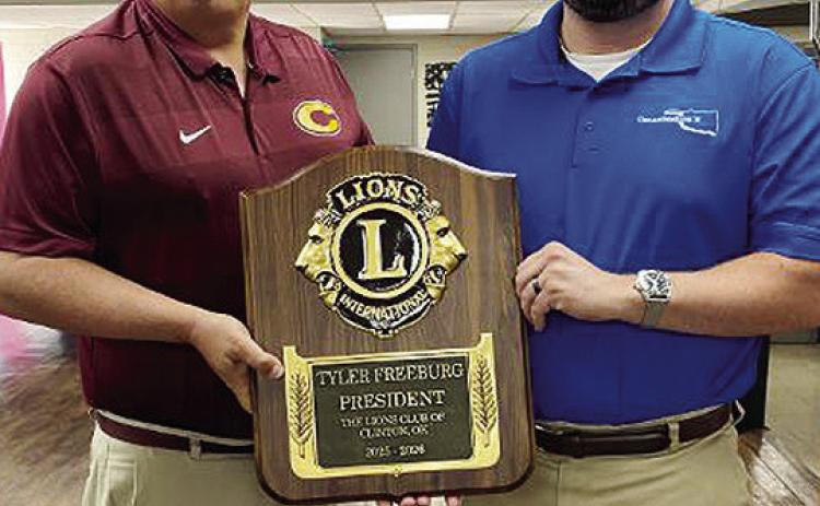 Tyler Freeburg, right, is presented a plaque recognizing his tenure as president of the Clinton Noon Lions Club from Brent Caldwell, current president of the civic group. CDN | Staff Photo
