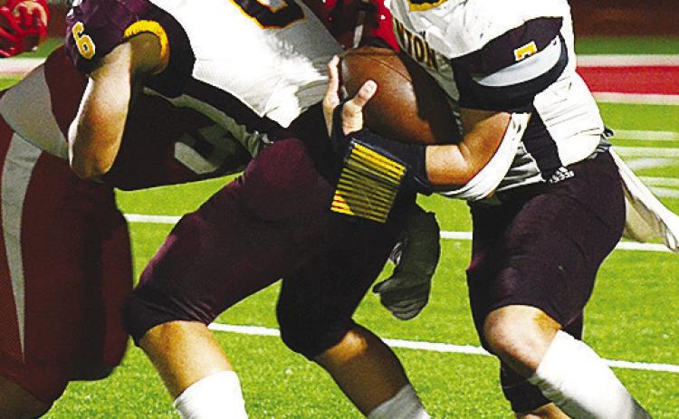 CDN |Micah Ashcraft Clinton’s No. 6 Benton Bridgeman blocks for sophomore quarterback Easten Powell as he takes the ball upfield during the Red Tornadoes’ road game against Cache.