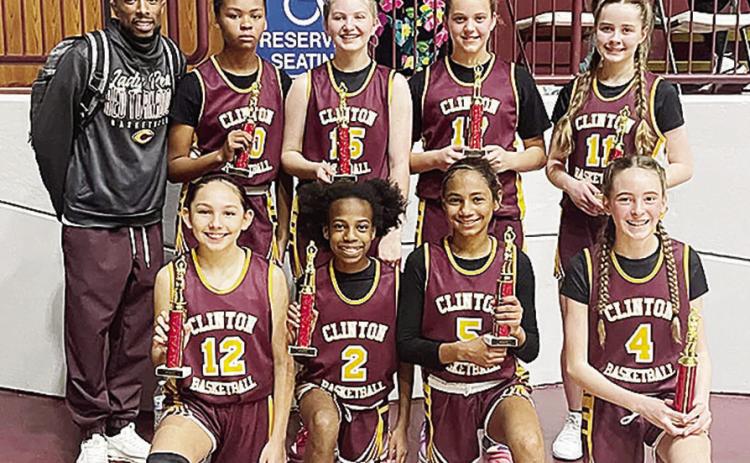 The sixth-grade girls’ basketball team shows off championship trophies from a recent tournament at the Tornado Dome. This group has won all but one tournament as a team. Pictured in front, from left, are Brielle Villalpando, Kynnedi Jefferson, Catalaya
