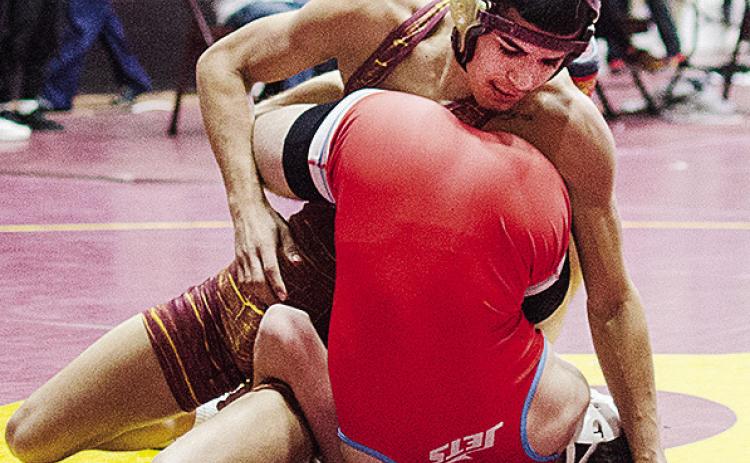 Clinton’s Vicente Gutierrez, top, tries to roll his opponent over during the annual Hub City Tournament Friday in the Tornado Dome. CDN | Sam Goodwyn