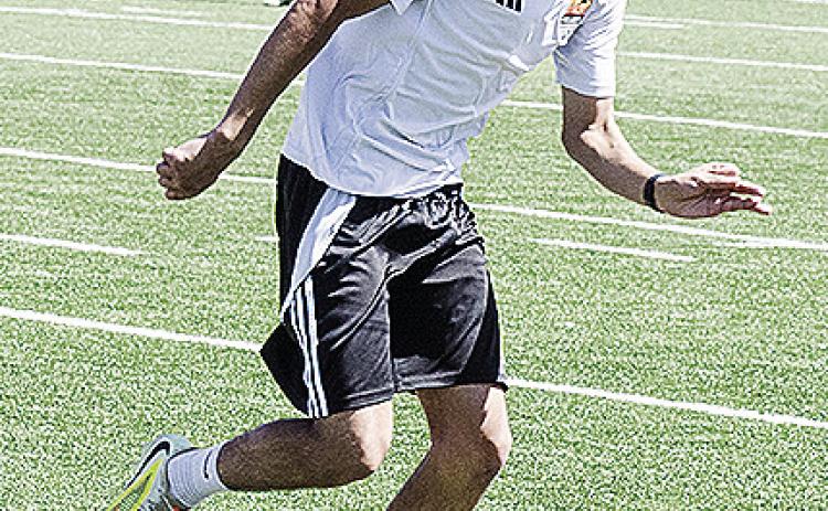 Recent Clinton graduate Antonio Soto runs with the ball during a practice this spring in the Tornado Bowl. CDN | Sam Goodwyn