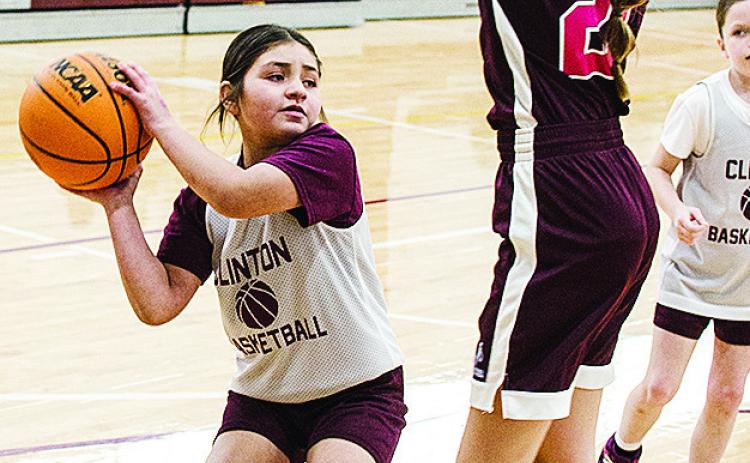 Maddi Esquivel, left, avoids the Sayre defender during Clinton’s fourth-grade girls’ basketball game at the practice gym. CDN |Sam Goodwyn