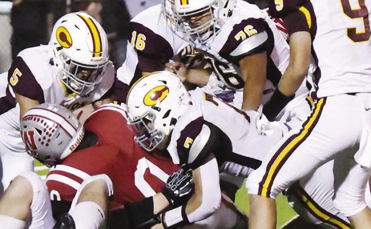 Clinton’s No. 5 Jesus Gutierrez pushes back against Weatherford’s Jakyah Grant as No. 7 Easten Powell, No. 76 Roderick Barker, No. 9 Parker Turney and No. 16 Reilon Woodford help out Friday in Weatherford during “The Custer County Conflict.” CDN | John Kinsey