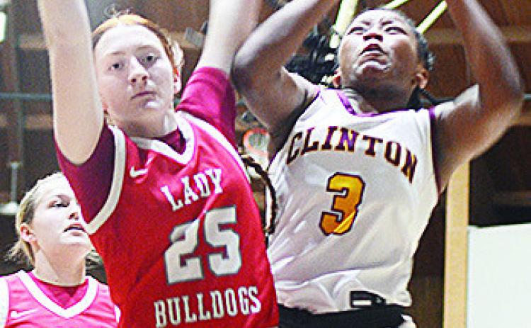 Clinton’s Arlena Kirkendoll battles against a defender as she goes up for the layup in the Lady Reds’ win over Cache. CDN | Sam Goodwyn