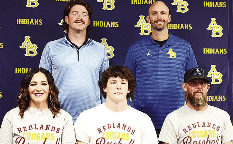Arapaho-Butler’s Rylan Moore, center, celebrates signing to play baseball for Redlands college in El Reno. Pictured in front, from left, are his mom Meagan Moore, and his dad Joey Moore; back, Coach Chase Johnson and Coach Bryan Holt. CDN | Sam Goodwyn