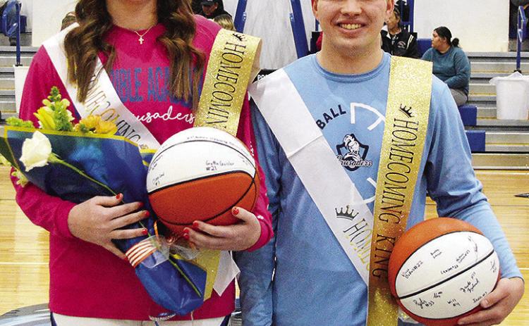 Kate Stewart, left, and Zack Zyback stand together at center court after being recognized as the Corn Bible Academy Basketball Homecoming Queen and King just before tip-off Thursday night. CDN | Micah Ashcraft