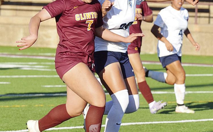 Clinton’s Lexie Conway battles with a PC West player for the ball during the Lady Reds’ home win Tuesday over the Lady Patriots. CDN | Sam Goodwyn