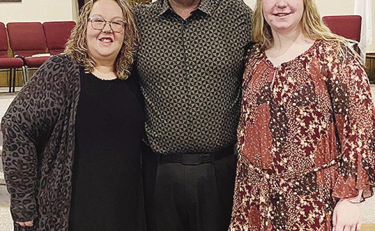 Jamie Patton, center, smiles with his wife Kelli, left, and daughter Carli after being selected as the new pastor at New Hope Fellowship Church. CDN | Courtesy photo