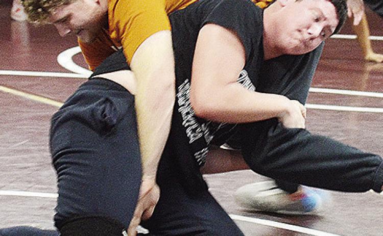 Clinton’s Marcus Wilson, top, grapples with Layne Spitz during wrestling practice last week. CDN |Sam Goodwyn