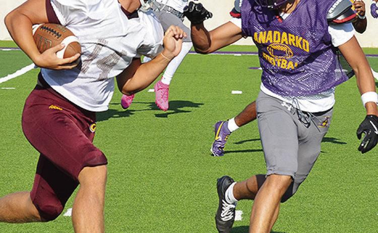 Clinton’s Vince Jones, left, hustles downfield as he prepares to fight off a defender during the Red Tornadoes’ scrimmage in Anadarko. CDN | Sam Goodwyn