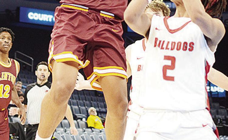 Clinton’s Titan Malone shoots a jump shot against a Cache defender during the Reds’ game Wednesday against the Bulldogs in the Paycom Center. CDN | Sam Goodwyn