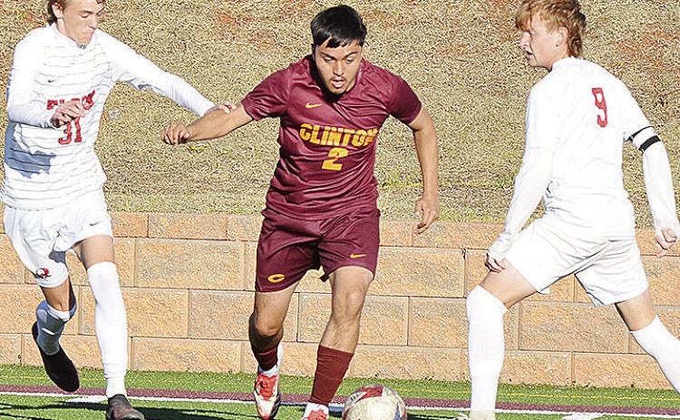 Clinton’s Alex Guzman splits two Elgin defenders during the Red Tornadoes’ win over the Owls in the Tornado Bowl. CDN | Sam Goodwyn