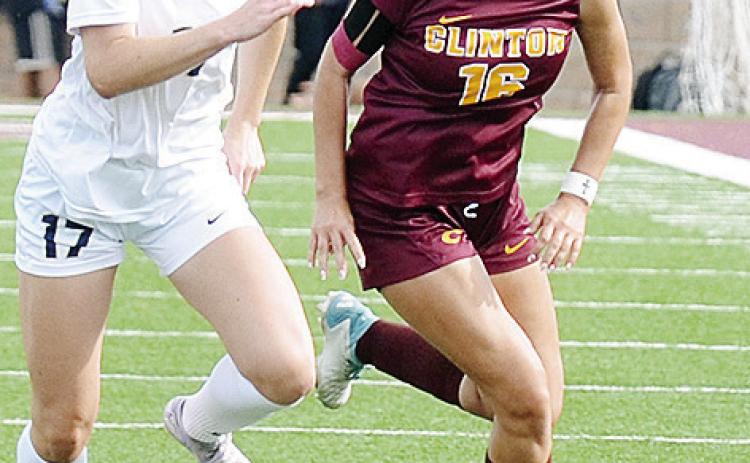 Clinton’s Lady Reds senior Emma McCommas races the Heritage Hall defender to the ball during Clinton’s regular-season ending game against the Lady Chargers in the Tornado Bowl. CDN | Sam Goodwyn