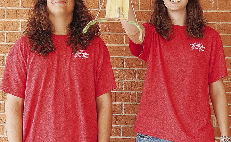Clinton High School seniors Maliki Jones, left, and Jackson McCullough show off their second-place winning project in the Helping Hands competition against other schools while at the University of Oklahoma’s Gallogly College of Engineering’s Open Hous