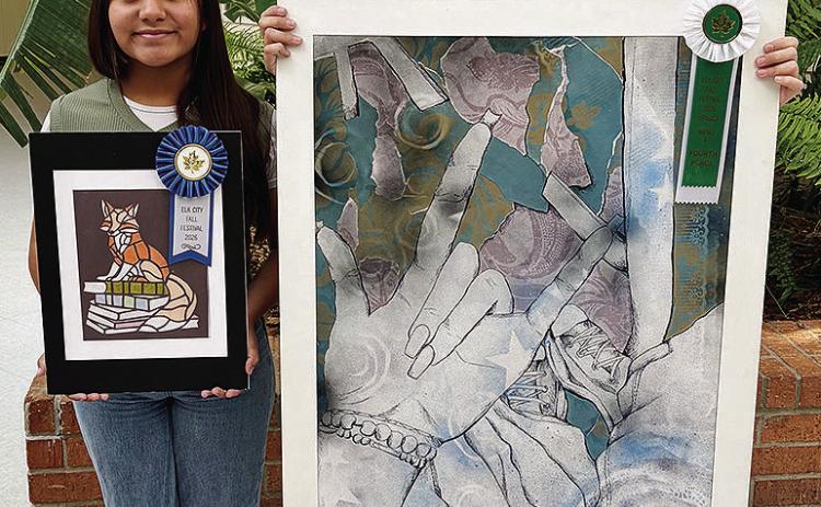 Valeria Vargas, left, and Harmoney Lee show their enteries into the Fall Festival of the Arts contest at CHS. Vargas received a blue ribbon for her “faux stained glass” fox, and Lee received fourth place in the Graphics 2 Division. CDN | Courtesy photo