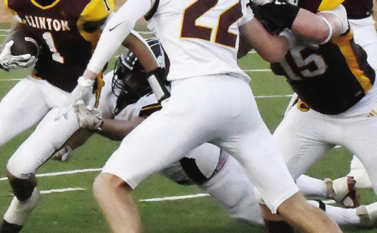 Clinton’s No. 15 Gavin Evans provides a block while No. 1 JJ Ruiz tries to find a hole during the Red Tornadoes’ win over the Lions. CDN | John Kinsey