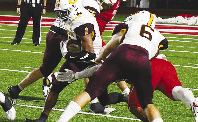 Clinton’s No. 6 Benton Bridgeman and No. 55 Bryson Snider provide key blocks for No. 1 Derren Hester as he carries the ball up the field during the Red Tornadoes’ road game Thursday against Cache. CDN | Micah Ashcraft